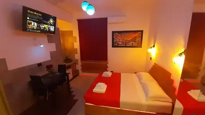 a hotel room with a bed and a television at HARMONY RELAX HYDROMASSAGE SAUNA AT THE VATICAN MUSEUMS in Rome