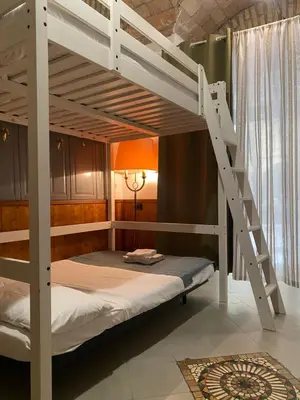a bunk bed in a room with a ladder at apartment vittorio Emanuele in Rome