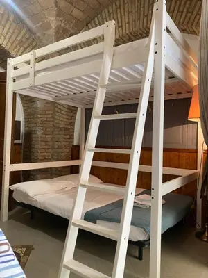 a white bunk bed with a ladder in a room at apartment vittorio Emanuele in Rome