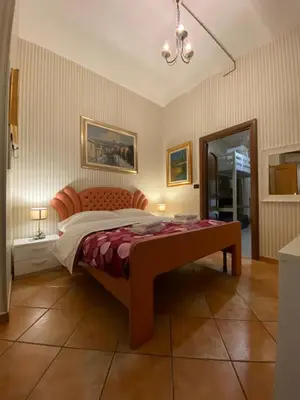 a bedroom with a bed and a mirror at apartment vittorio Emanuele in Rome