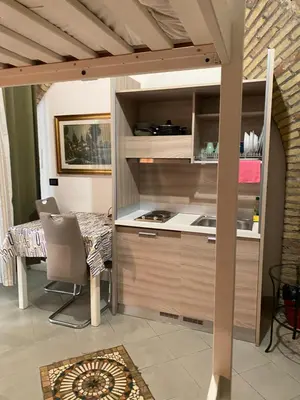 a kitchen and dining room with a table and chairs at apartment vittorio Emanuele in Rome