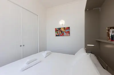 a bedroom with a white bed with two white towels at Corso View by Rental in Rome in Rome