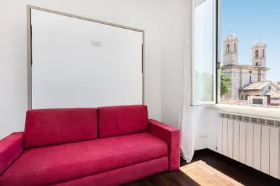 a red couch in a room with a window at Corso View by Rental in Rome in Rome