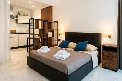 a bedroom with a large bed with towels on it at Laura's Rooms a due passi dal Vaticano - RIONI DI ROMA in Rome
