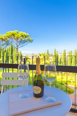 a bottle of champagne and two wine glasses on a table at Laura's Rooms a due passi dal Vaticano - RIONI DI ROMA in Rome