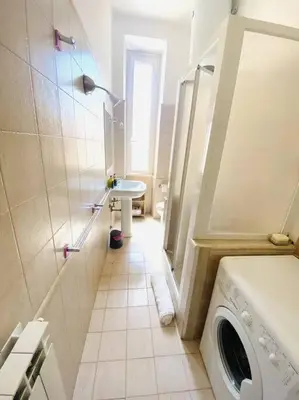a bathroom with a washing machine and a sink at Crisalide Apartment in Rome