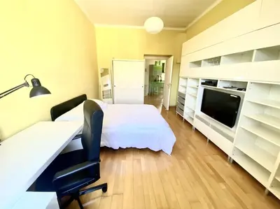 a bedroom with a bed and a desk and a tv at Crisalide Apartment in Rome