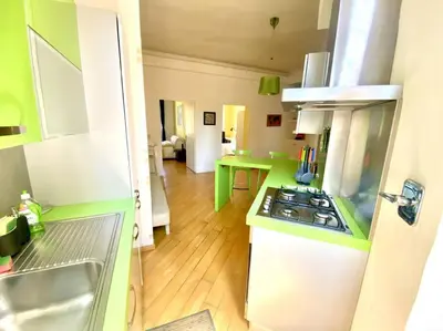 a kitchen with green and white counters and a stove at Crisalide Apartment in Rome