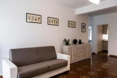 a living room with a couch and a wooden cabinet at Appartamento Appio Latino in Rome