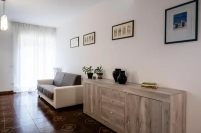 a living room with a couch and a chair at Appartamento Appio Latino in Rome