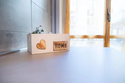 a box with the words home next to a table at Appartamento Appio Latino in Rome