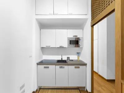 a white kitchen with a sink and a microwave at (Piazza di spagna)Rome Apartment in Rome
