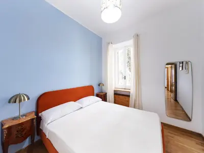 a bedroom with a white bed and a mirror at (Piazza di spagna)Rome Apartment in Rome