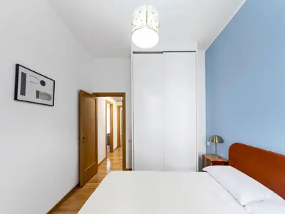 a white bedroom with a bed and a lamp at (Piazza di spagna)Rome Apartment in Rome