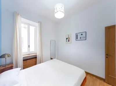 a white bedroom with a bed and a window at (Piazza di spagna)Rome Apartment in Rome