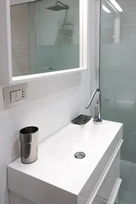 a white bathroom with a sink and a mirror at Family apartment near Vatican Museum in Rome