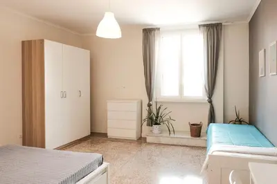 a bedroom with two beds and a window at Family apartment near Vatican Museum in Rome