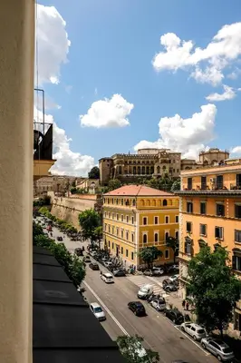 a view of a city street with cars and buildings at Family apartment near Vatican Museum in Rome