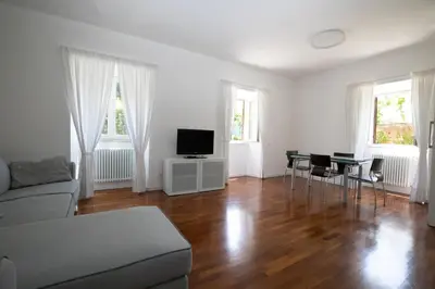 a living room with a couch and a table with chairs at Domus Cordara - Splendido appartamento nel verde in Rome