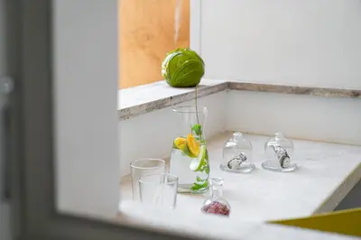 a sink with glasses and a green ball on it at iFlat Wood and Marble Riverfront in Rome
