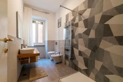a bathroom with a toilet and a sink at GuestHost - Rione Prati Comfy Apartment in Rome