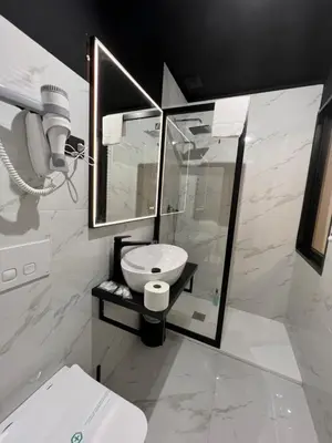 a white bathroom with a sink and a shower at Viminale Domus in Rome