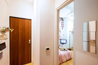 a hallway leading to a bedroom with a bed at B&B La stanza di Zoe - Roma Tre Metro B Marconi in Rome