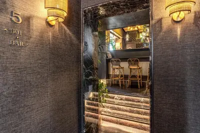 a door to a restaurant with a table and chairs at TB Place Roma in Rome