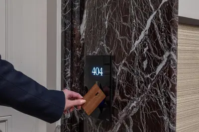 a person holding a wooden block with a clock on a wall at TB Place Roma in Rome