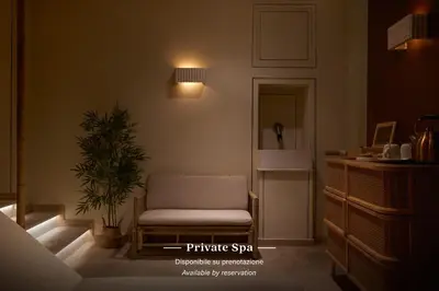 a living room with a chair and a plant at TB Place Roma in Rome