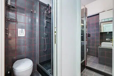a bathroom with a toilet and a shower at King's House - San Giovanni/Re di Roma in Rome