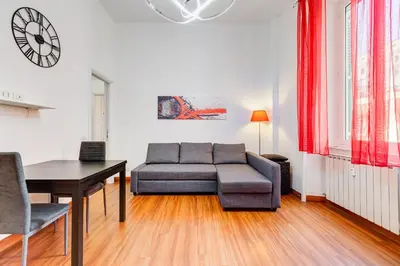 a living room with a couch and a table at King's House - San Giovanni/Re di Roma in Rome