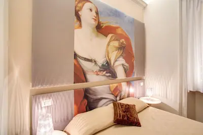 a painting of a woman on a wall in a room at Roma In Una Stanza Guesthouse in Rome