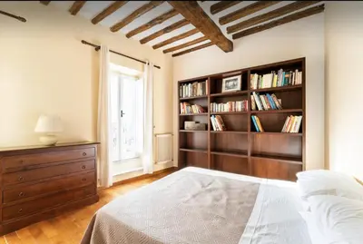 a bedroom with a bed and a book shelf at Piazza Navona Center House in Rome