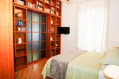 a bedroom with a bed and a mirror at Karisma Suites in Rome