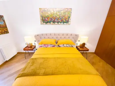 a mirror on a table with a white chair and a mirror at Karisma Suites in Rome
