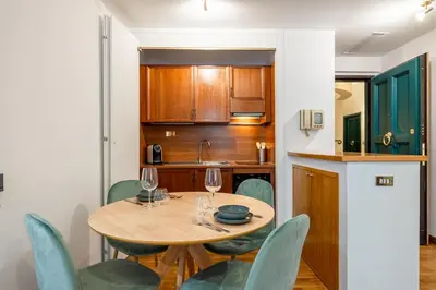 a kitchen and dining room with a table and chairs at Frezza Charming Suite in Rome