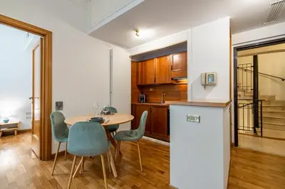 a kitchen and dining room with a table and chairs at Frezza Charming Suite in Rome