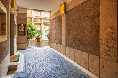 a tiled hallway with a brick floor and a window at Frezza Charming Suite in Rome