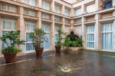 a large building with windows and potted plants on the floor at Frezza Charming Suite in Rome