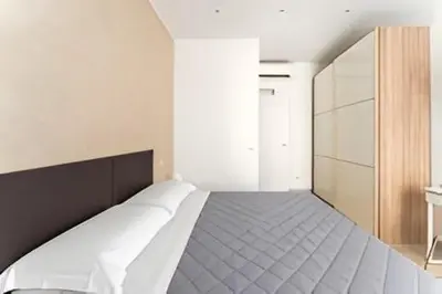 a bedroom with a bed in a white room at First Floor Apartment in Rome