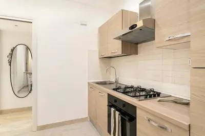 a kitchen with a stove and a sink at First Floor Apartment in Rome