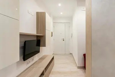 a living room with a flat screen tv on a wall at First Floor Apartment in Rome