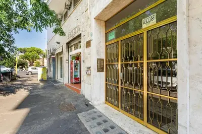 a store front with a window filled with wine bottles at First Floor Apartment in Rome