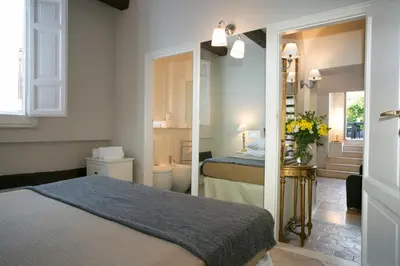 a hotel room with a bed and a bathroom at Your Prestigious Penthouse at the Spanish Steps in Rome
