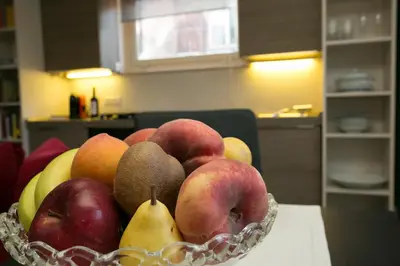 a bowl of apples and pears on a table at Your Prestigious Penthouse at the Spanish Steps in Rome