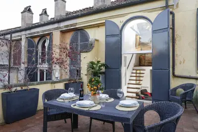 a table and chairs on a patio at Your Prestigious Penthouse at the Spanish Steps in Rome