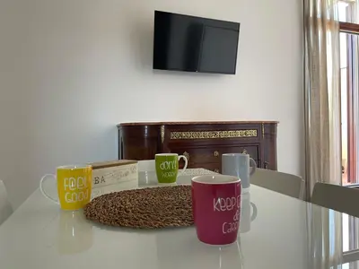 three coffee mugs sitting on a glass table at Caracciolo33 in Rome