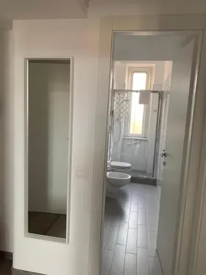 a bathroom with a toilet and a glass door at Caracciolo33 in Rome