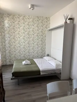 a bedroom with a bed and two chairs in it at Caracciolo33 in Rome